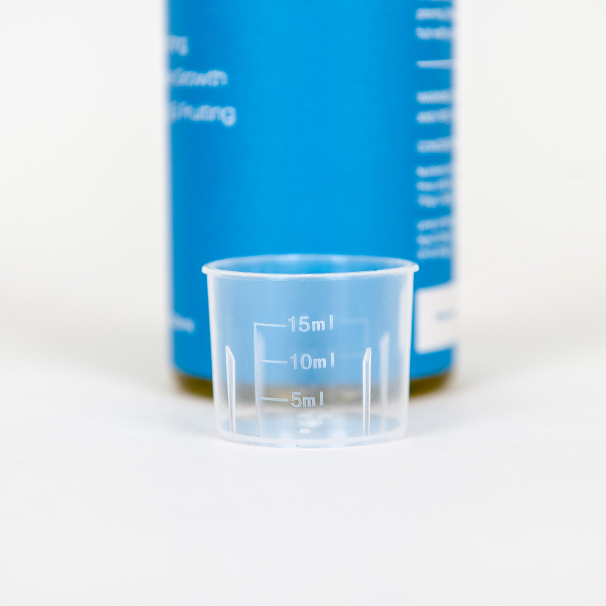 Clear measuring cup with Hydroboost bottle in the background.