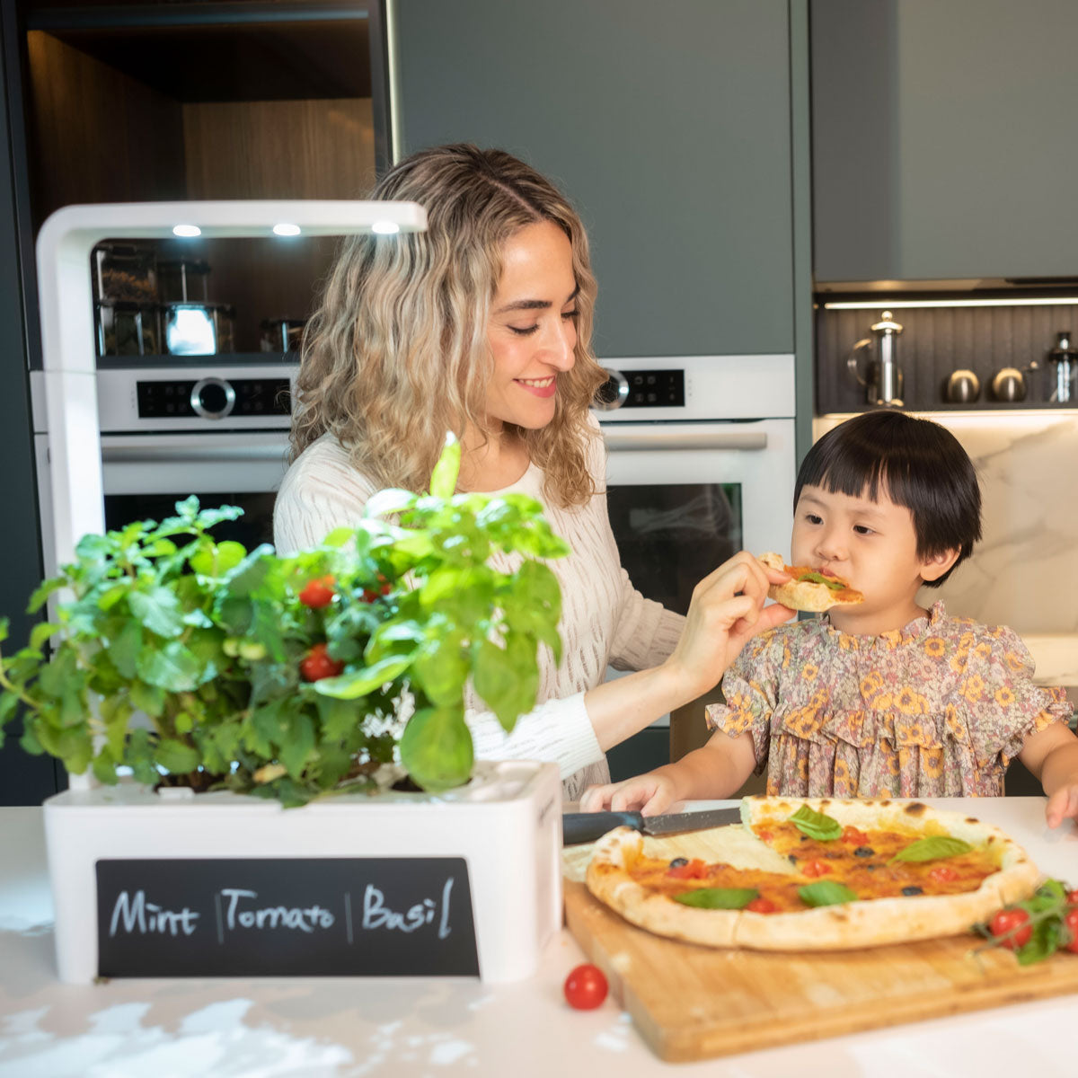 child eating pizza with basil picked from Hydrogarden 3.