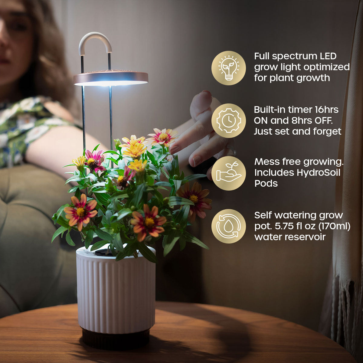 woman touching flowers growing in her indoor grow vase