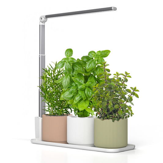 Modern indoor garden with potted plants and a LED grow light on a white background